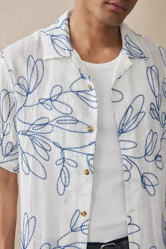 White cotton camp shirt with all-over blue leaf embroidery, short sleeves