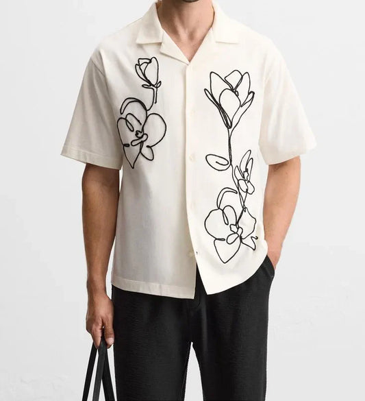 Off-white cotton camp shirt with black line embroidery of orchid flowers